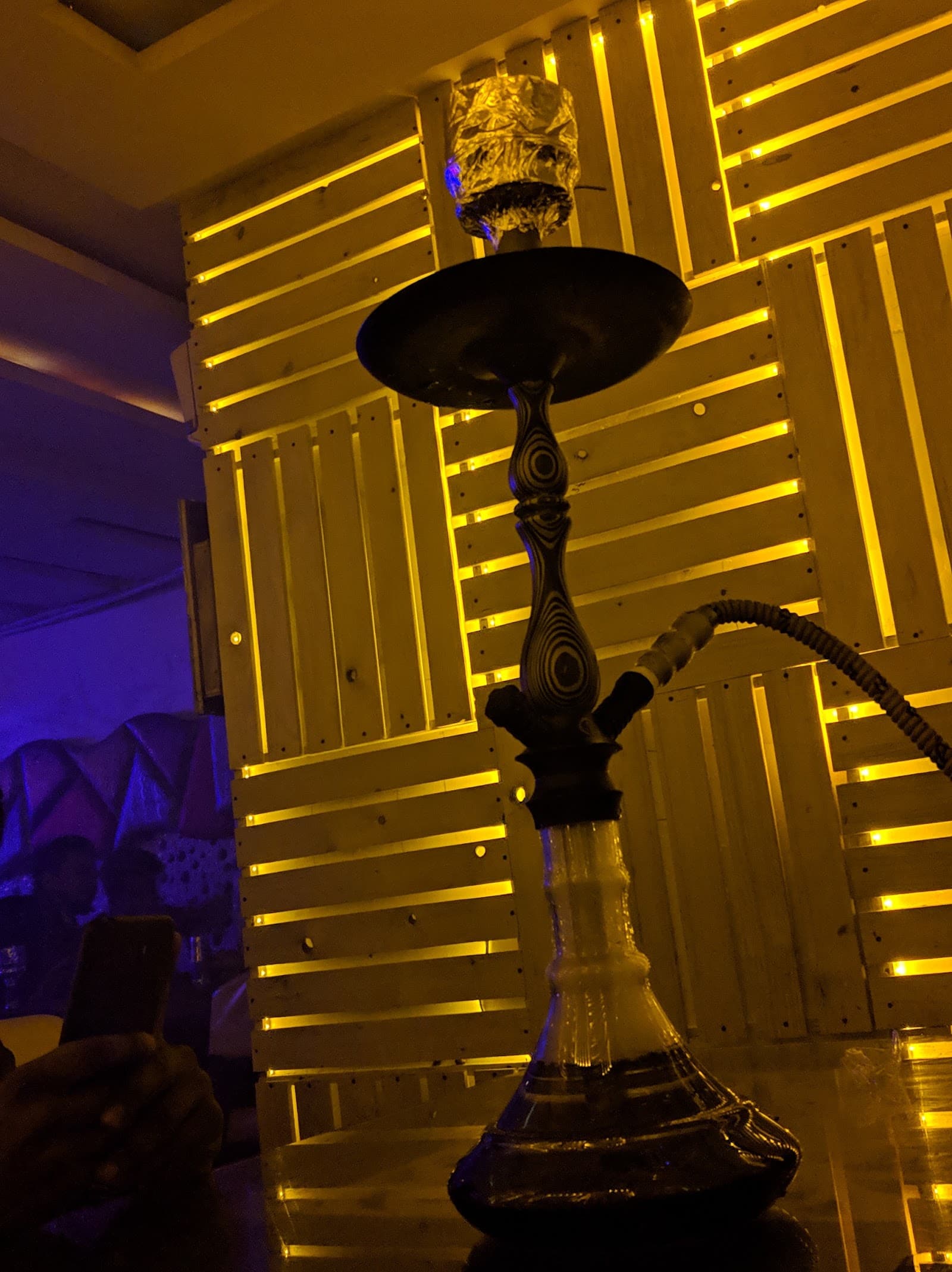 Hookah against a gold slatted wall